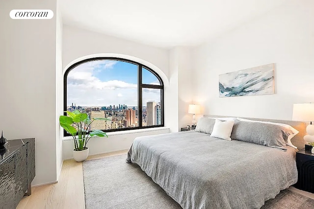 130 William St Unit 46A, New York City, NY 10038 - bedroom with wood finished floors and a city view