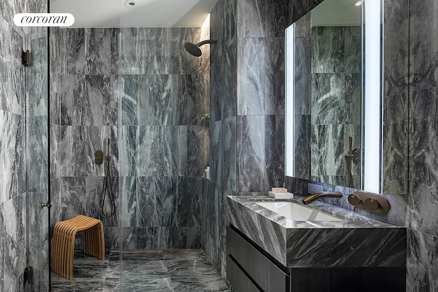 bathroom featuring a tile shower and vanity