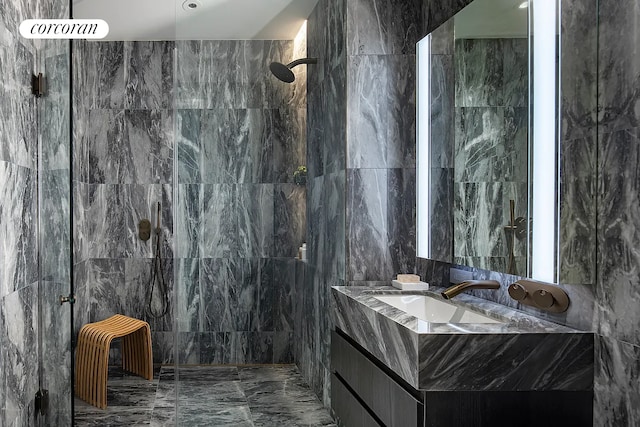 130 William St Unit 46A, New York City, NY 10038 - bathroom featuring tile walls, marble finish flooring, vanity, and a walk in shower