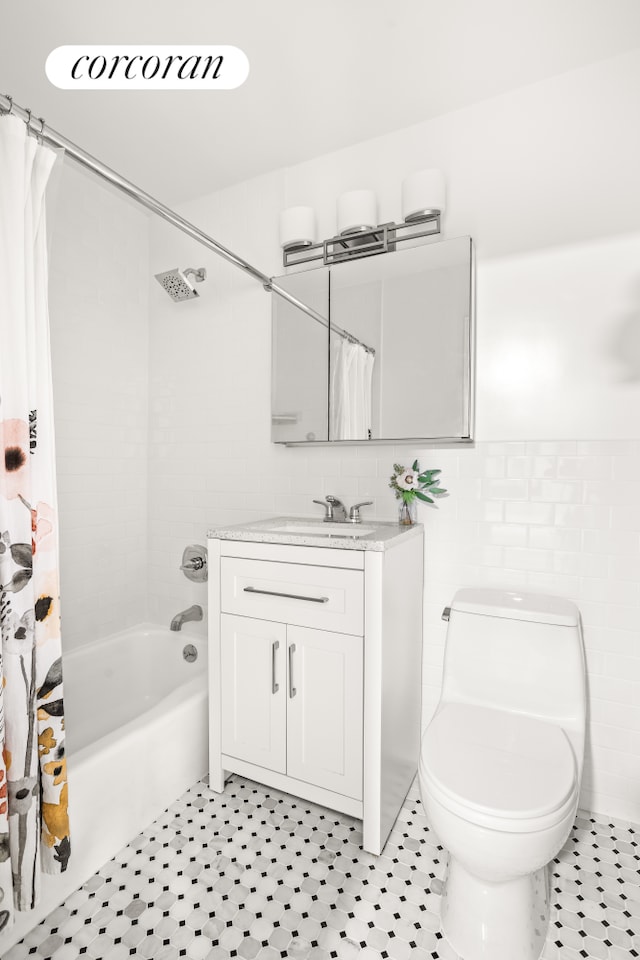 full bathroom with toilet, shower / bath combo, vanity, and tile walls