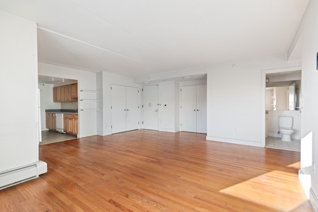 1885 Lexington Ave Unit 5A, New York City, NY 10035 - unfurnished living room with light wood-type flooring and a baseboard heating unit