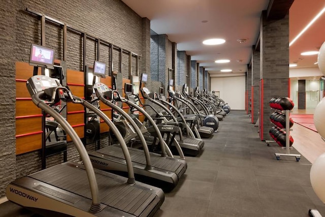 exercise room featuring a towering ceiling