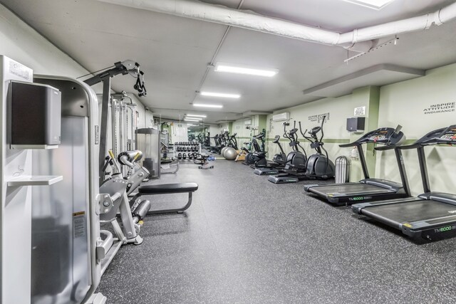 exercise room with a wall unit AC