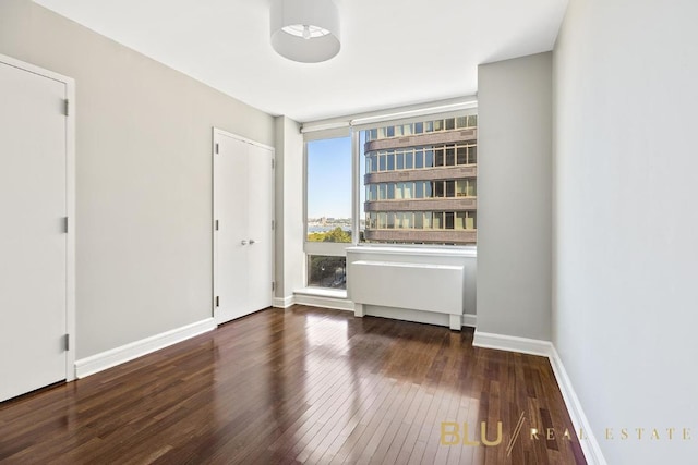 unfurnished room featuring dark hardwood / wood-style floors