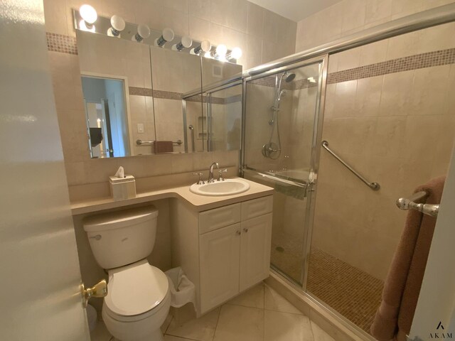 bathroom with toilet, tile patterned floors, and vanity