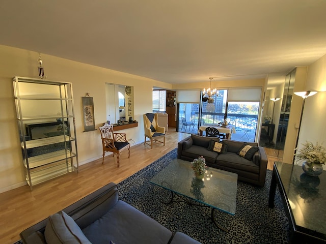 living room featuring a chandelier, wood finished floors, and baseboards