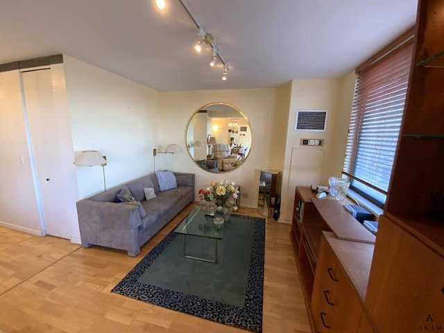 living area featuring visible vents, light wood-style flooring, and track lighting