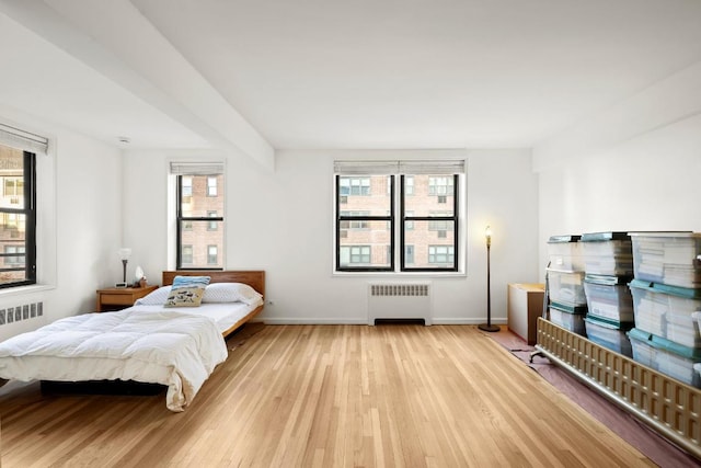 bedroom featuring radiator and light wood-type flooring