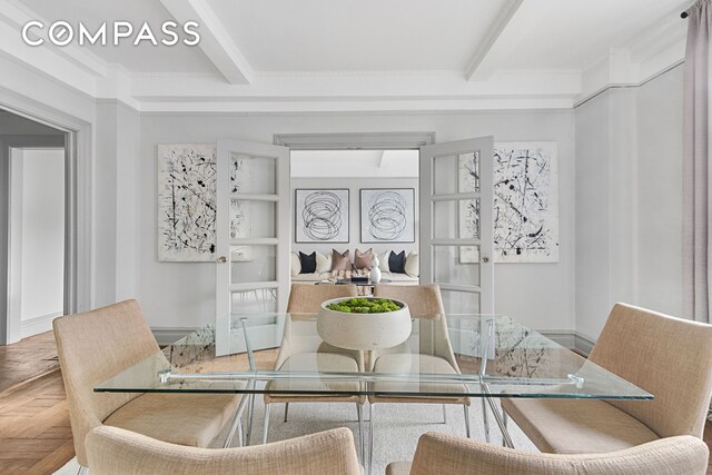 dining space featuring baseboards and beam ceiling