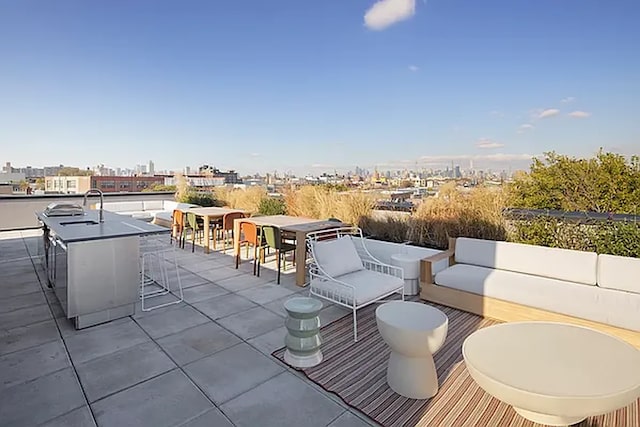 view of patio with a view of city, outdoor dining space, outdoor lounge area, and a sink