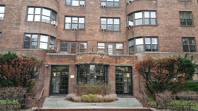 exterior space featuring cooling unit and brick siding