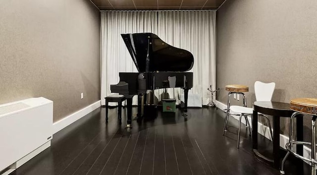 miscellaneous room featuring wood finished floors and baseboards