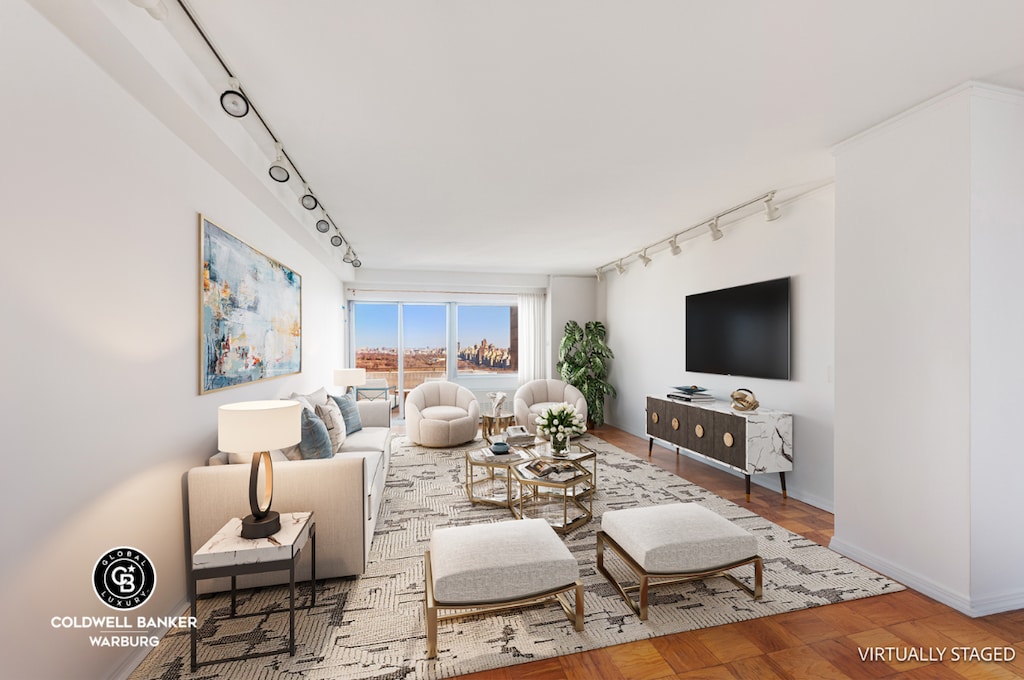 living room with parquet flooring and track lighting