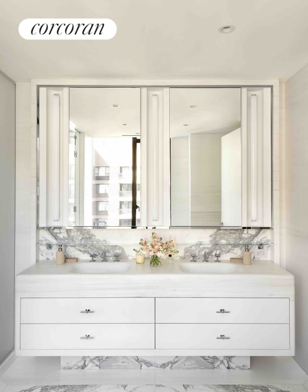 bathroom featuring vanity and backsplash