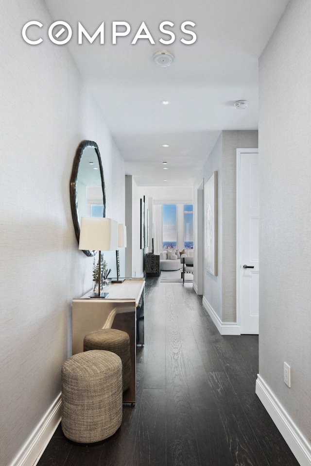 hall with dark wood finished floors and baseboards