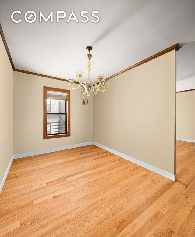 living room featuring hardwood / wood-style flooring, ornamental molding, and a notable chandelier