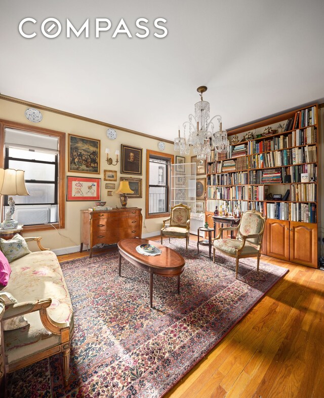 spare room featuring crown molding, a chandelier, and hardwood / wood-style flooring