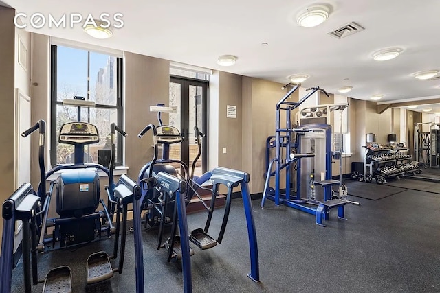 gym with french doors, visible vents, and baseboards