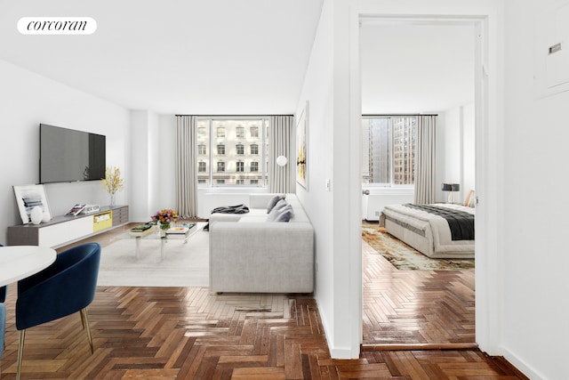 living area with a wealth of natural light, visible vents, and baseboards