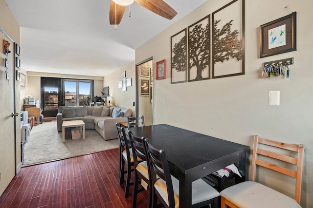 dining room with ceiling fan and dark hardwood / wood-style flooring