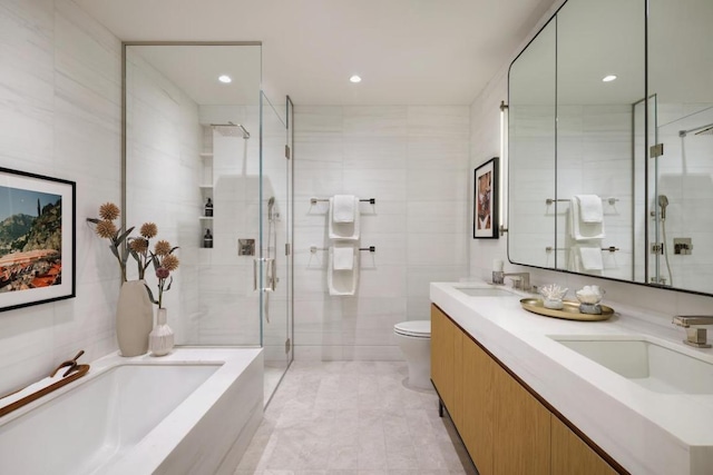 full bathroom featuring toilet, shower with separate bathtub, tile walls, and vanity