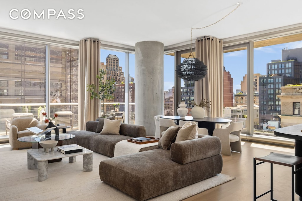 living room with a view of city, wood finished floors, and expansive windows