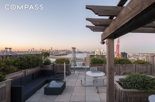 view of patio with an outdoor hangout area and a city view