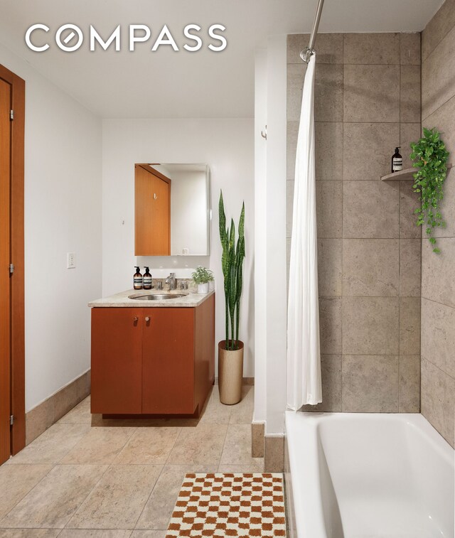 440 Kent Ave Unit 22C, New York City, NY 11249 - full bathroom with vanity, baseboards, and shower / bath combination with curtain