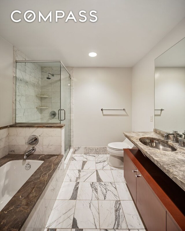 bathroom featuring vanity, toilet, recessed lighting, a bath, and a shower stall