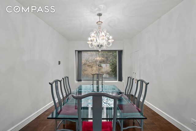 dining space with a notable chandelier and baseboards