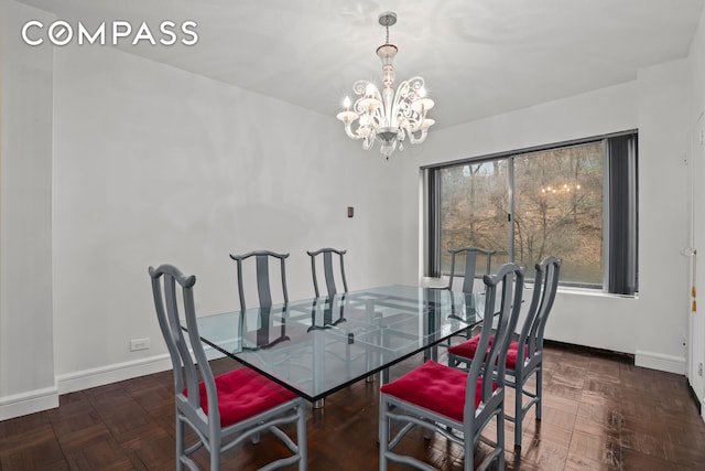 dining area with a notable chandelier and baseboards