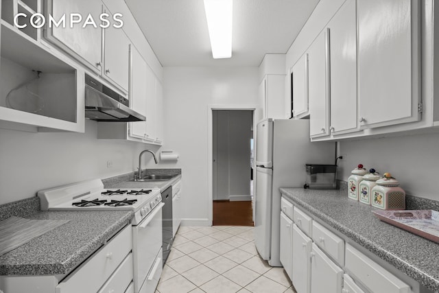 kitchen featuring white appliances, under cabinet range hood, white cabinetry, a sink, and light tile patterned flooring