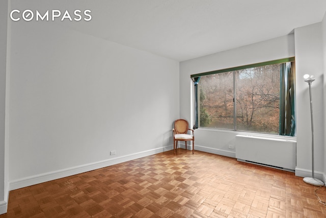 empty room with radiator and baseboards