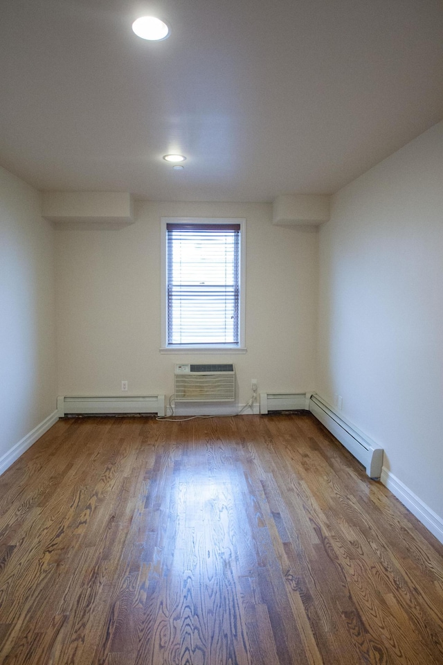 712 6th Ave Unit 4, New York City, NY 11215 - unfurnished room featuring baseboard heating, wood finished floors, a wall mounted air conditioner, recessed lighting, and baseboards