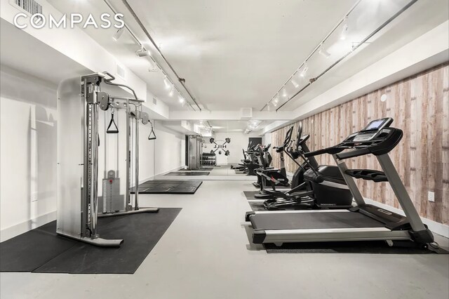 gym with wood walls and track lighting