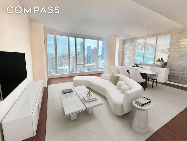 living room featuring a wealth of natural light, a city view, and wood finished floors