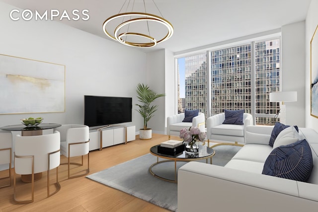 living room featuring a wall of windows, wood finished floors, and a notable chandelier