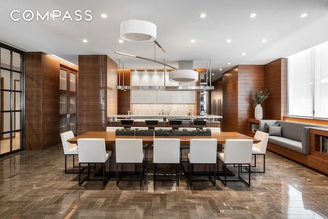 kitchen with light countertops, a large island, a breakfast bar area, and modern cabinets