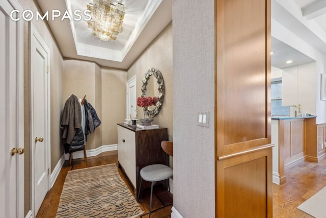 hallway with baseboards and wood finished floors