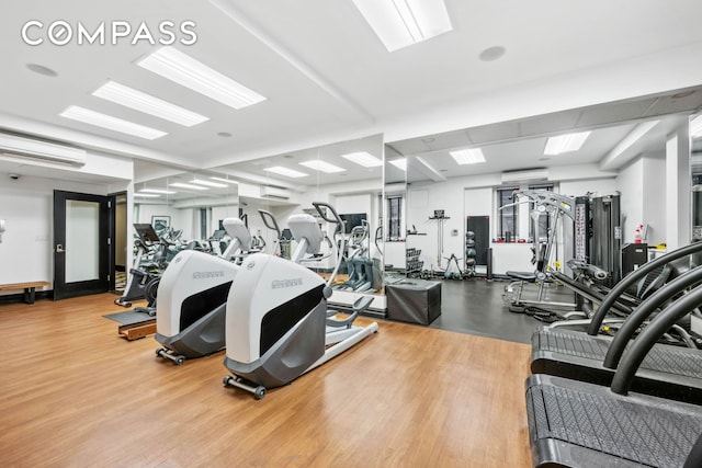 25 5th Ave Unit 6C, New York City, NY 10003 - workout area featuring a wall mounted air conditioner, wood finished floors, and a wall unit AC