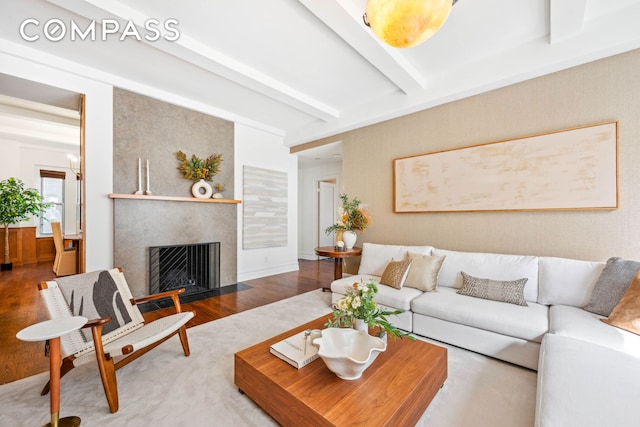 25 5th Ave Unit 6C, New York City, NY 10003 - living area featuring beam ceiling, wood finished floors, and a fireplace