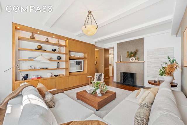 25 5th Ave Unit 6C, New York City, NY 10003 - living area with beam ceiling, wood finished floors, and a large fireplace