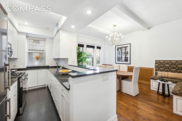 25 5th Ave Unit 6C, New York City, NY 10003 - kitchen featuring appliances with stainless steel finishes, a sink, white cabinetry, a chandelier, and recessed lighting