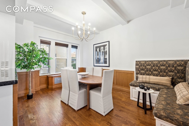 25 5th Ave Unit 6C, New York City, NY 10003 - dining area with beam ceiling, wood finished floors, a chandelier, and wainscoting