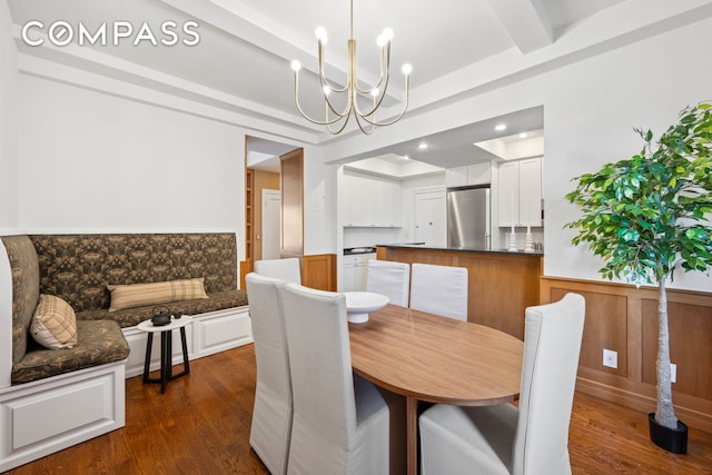 25 5th Ave Unit 6C, New York City, NY 10003 - dining room featuring a chandelier, dark wood-style floors, beamed ceiling, and wainscoting