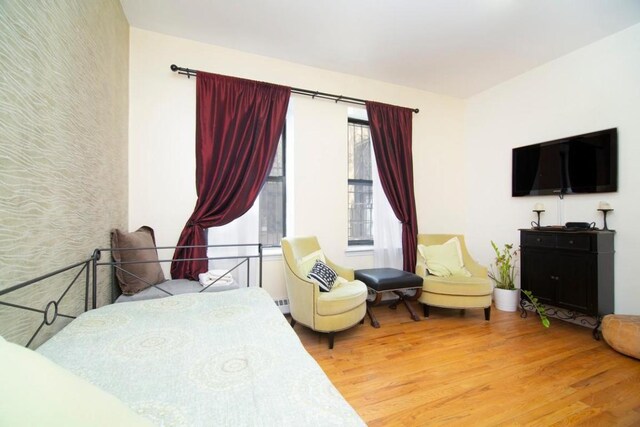 bedroom with hardwood / wood-style flooring