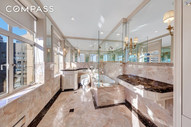 full bath with vanity, a garden tub, a healthy amount of sunlight, and marble finish floor