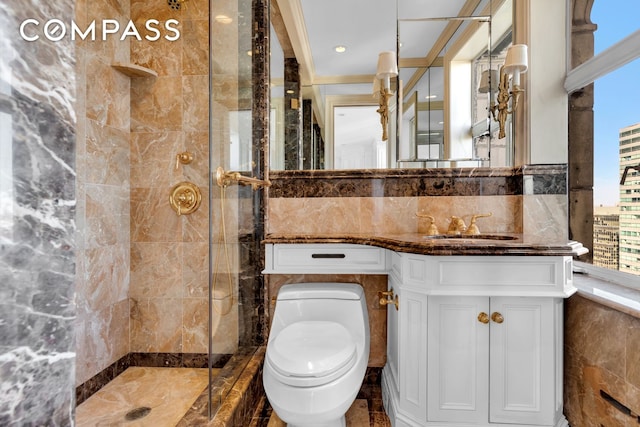 bathroom featuring tiled shower, toilet, tile walls, and vanity