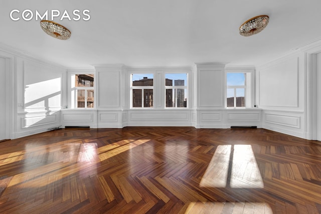 empty room with a decorative wall and crown molding