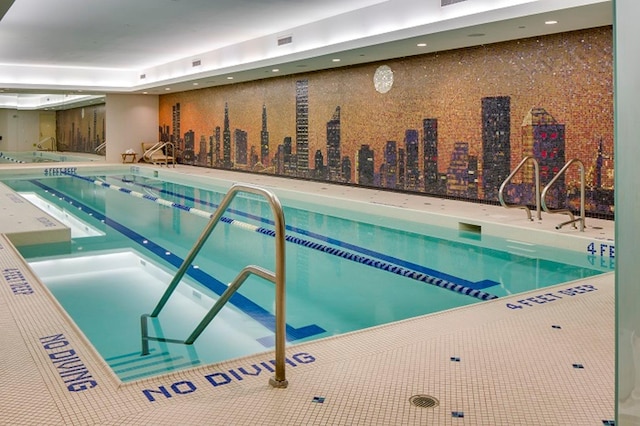 view of swimming pool with a hot tub